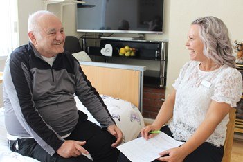 Community nurse with patient in his home